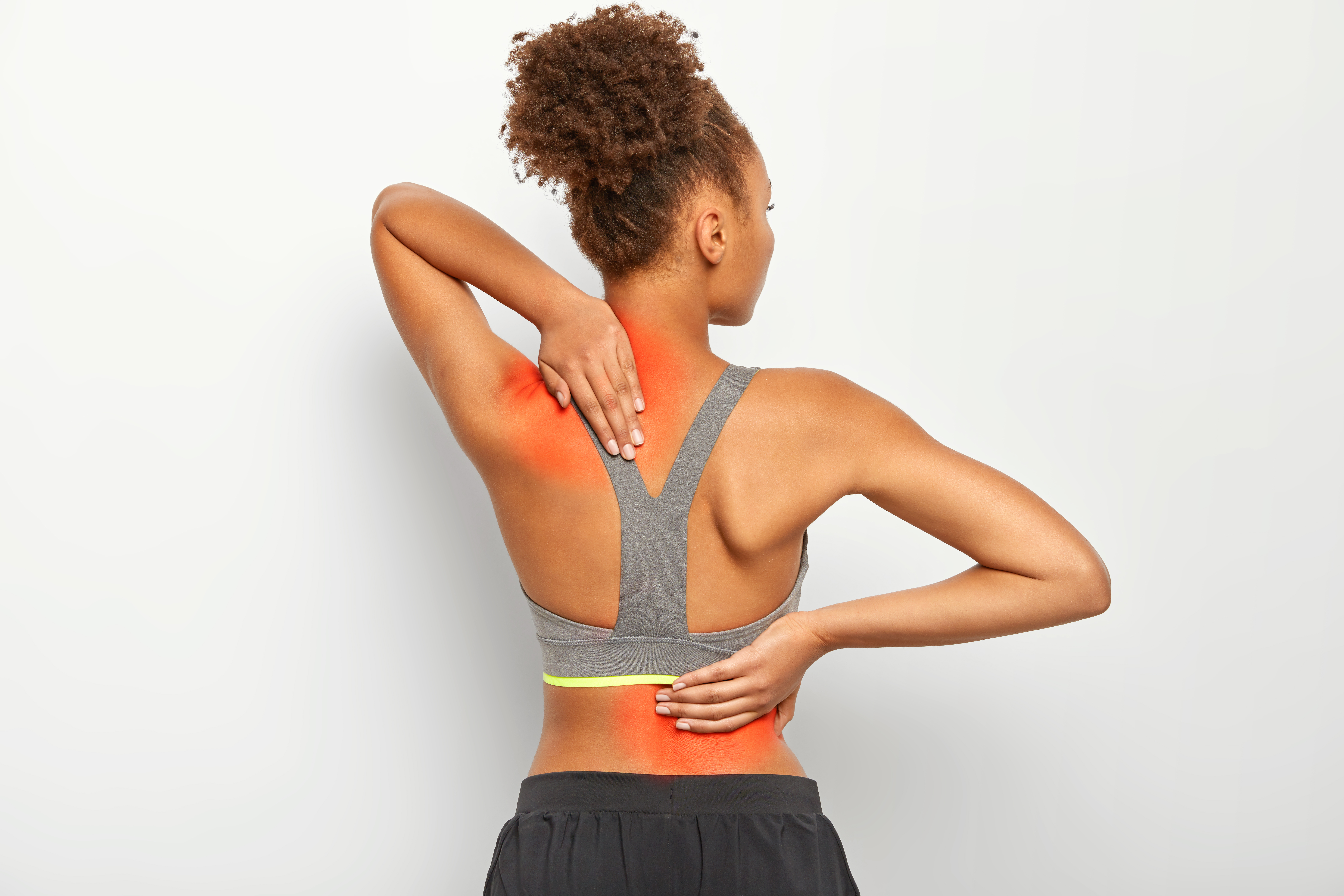 faceless-curly-woman-suffers-from-spine-pain-wears-sport-bra-shows-location-of-inflammation-isolated-on-white-background.jpg