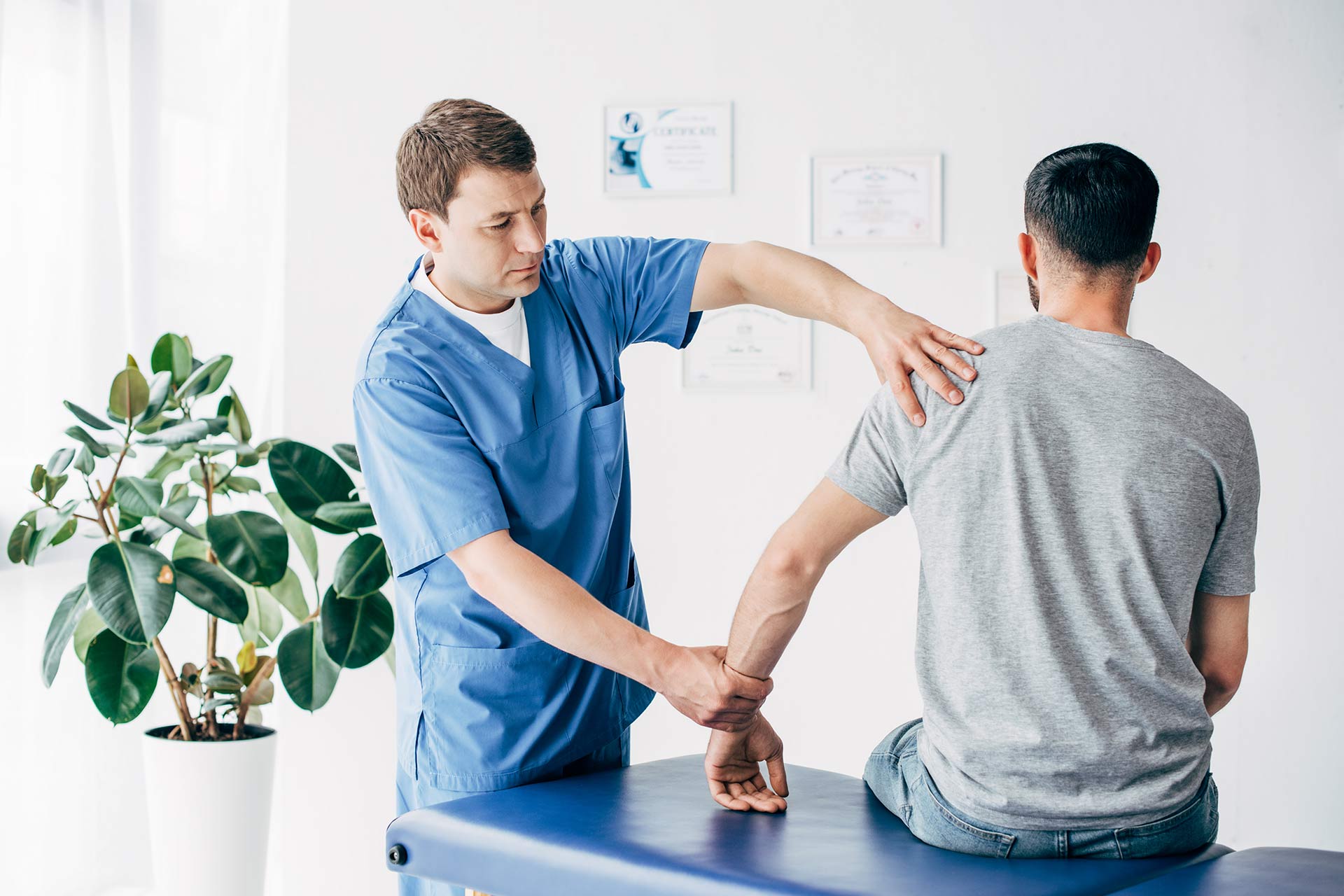 physiotherapist-massaging-arm-of-patient-on-massag-2024-11-01-05-24-00-aemujs7.jpg