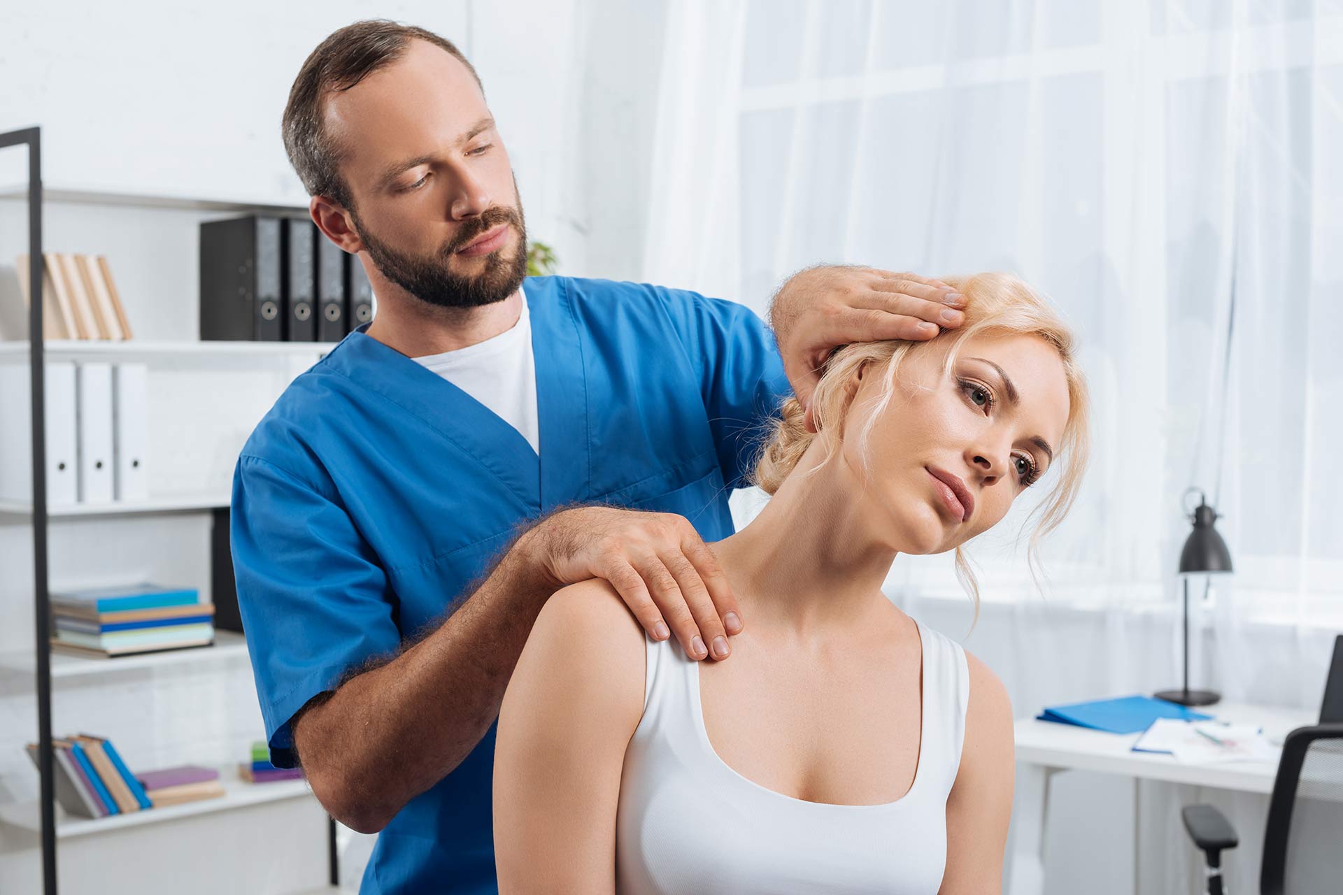 portrait-of-chiropractor-stretching-neck-of-woman-2024-11-01-03-36-52-updd2zq.jpg